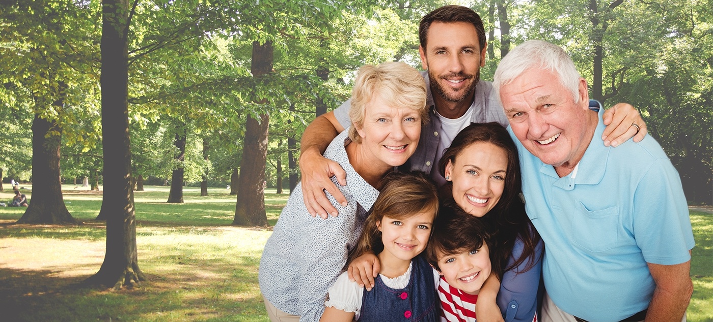 Parents grand parents and kids smiling outside