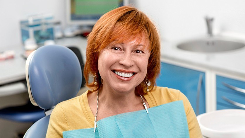 Older woman in dental chair smiling