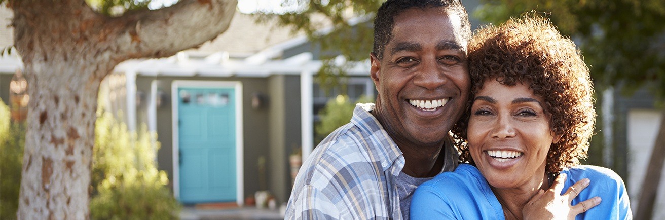 Older man and woman outdoors smiling