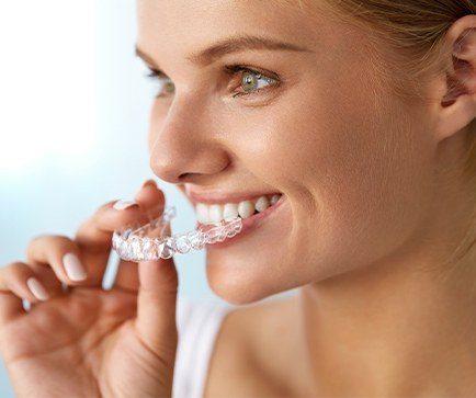 Woman placing an Invisalign tray