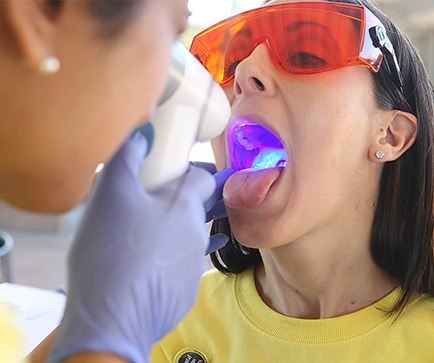 Dentist performing oral cancer screening