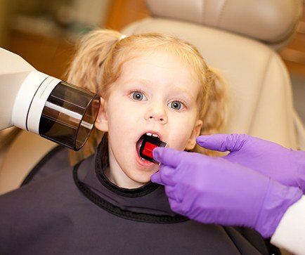 Child receiving dental x-rays