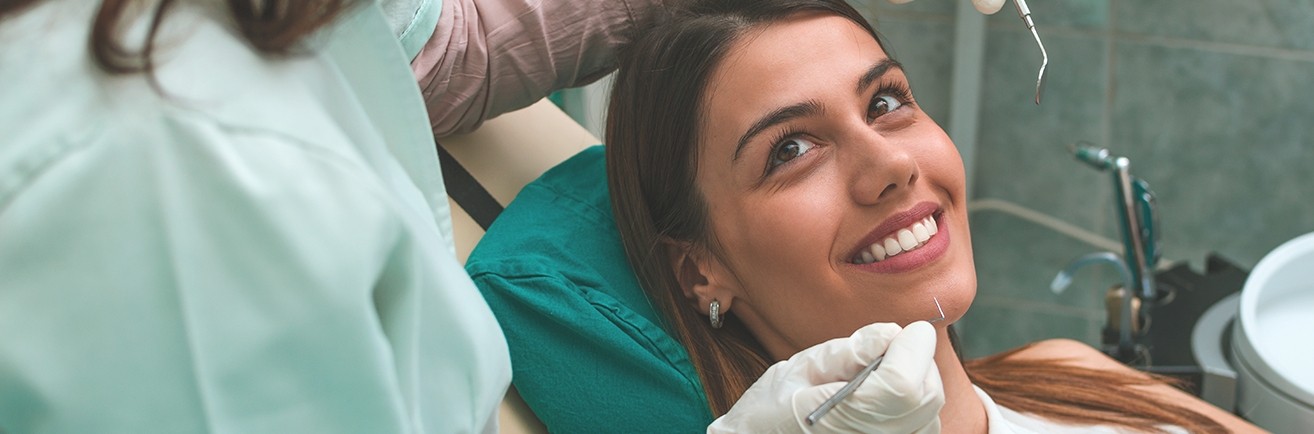 Woman in dental chair smiling