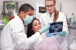 dentist showing patient dental x-rays 