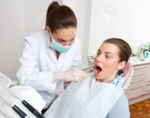 woman looking scared at dentist