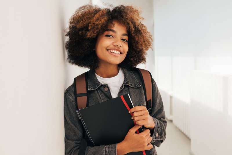 a student smiling with good oral health at school